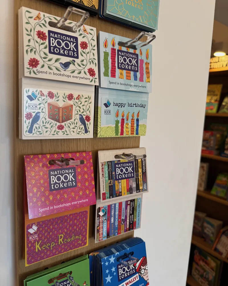 National Book Tokens on the shop wall in a dozen designs, from florals to Where's Wally