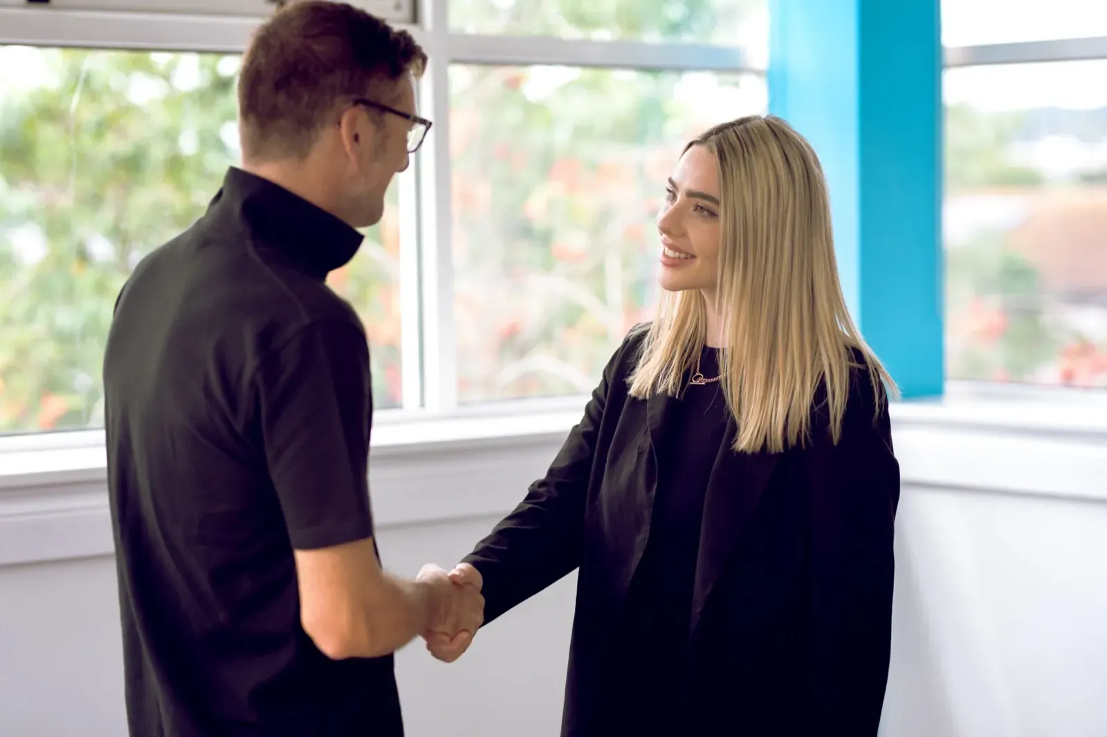 Sales people shaking hands