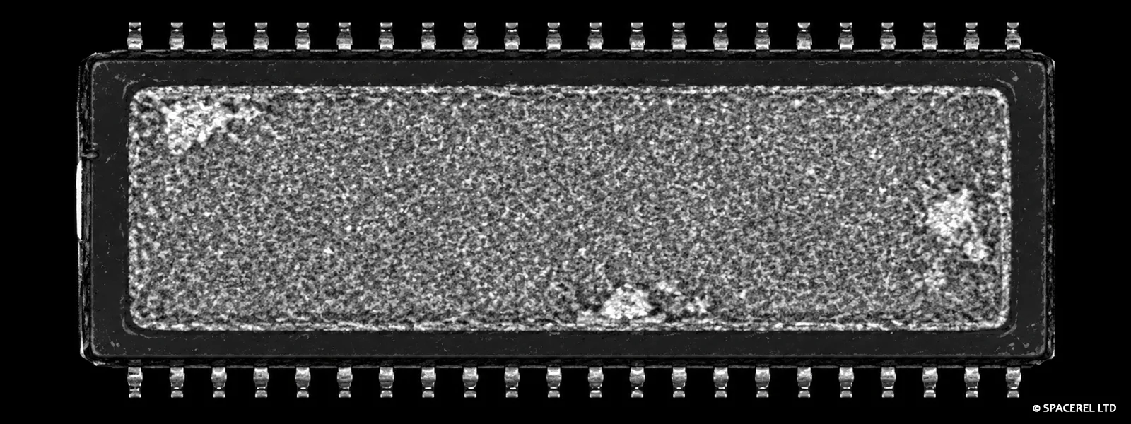 C-SAM image of a rectangular semiconductor package showing localised internal delamination regions