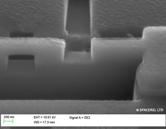 FIB cross-section of a microelectronic structure showing site-specific milling at sub-micrometre scale